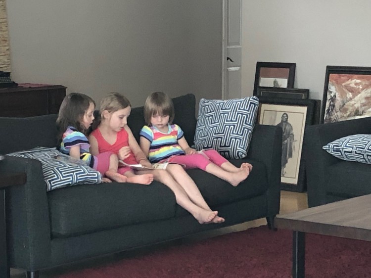 sisters reading together nicely
